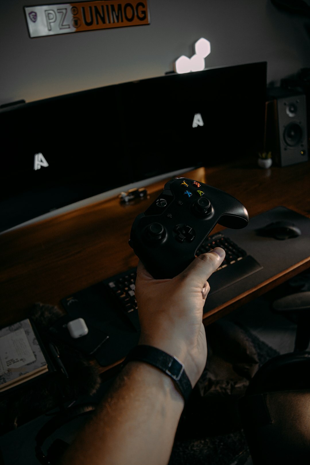 Video editor working at a desk with multiple monitors showing footage