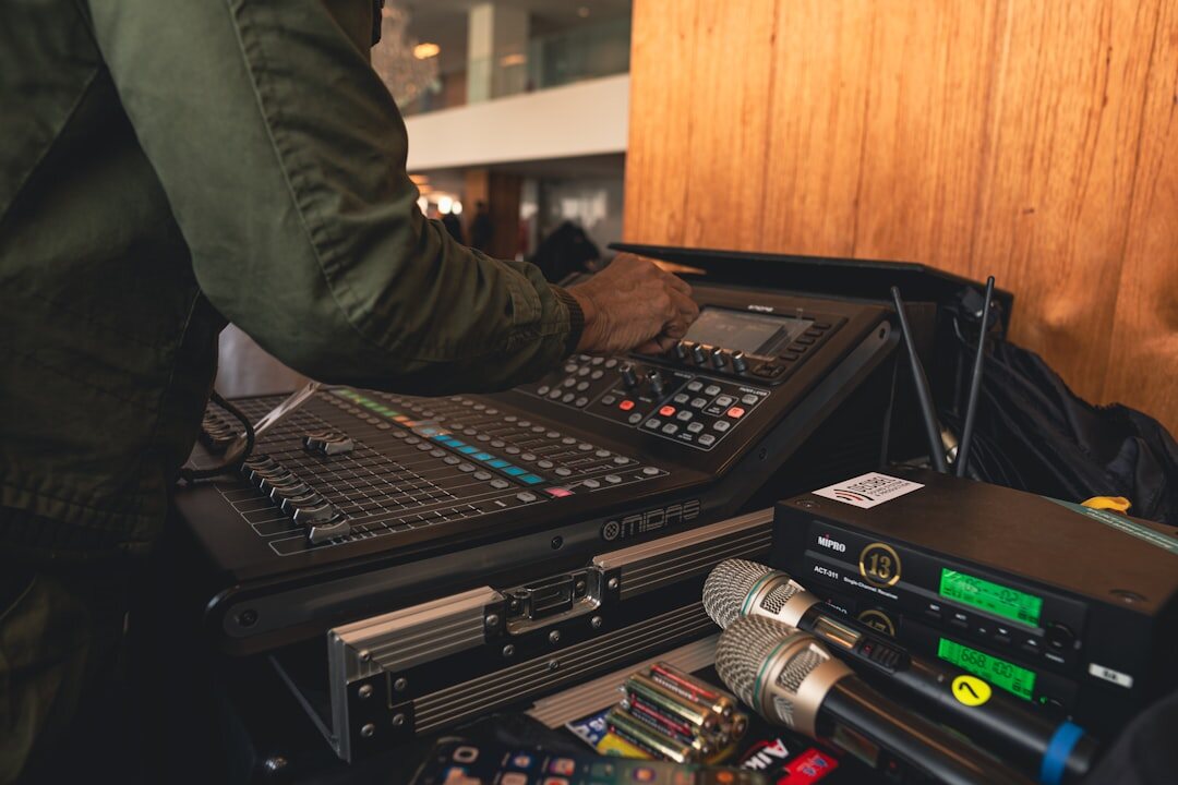 Technician operating live broadcast equipment with rack mounted devices